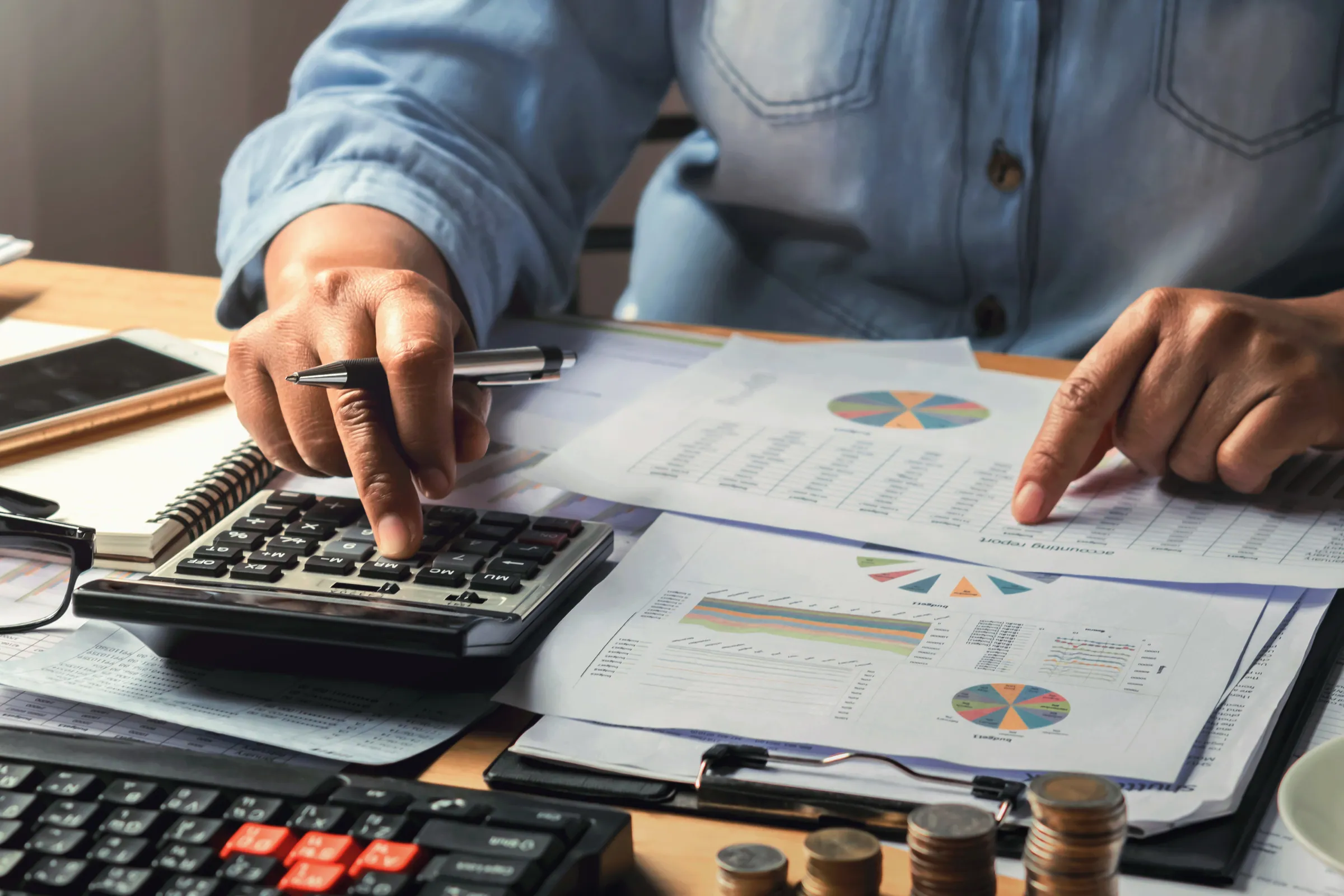 Accountant working through figures and reports at a desk