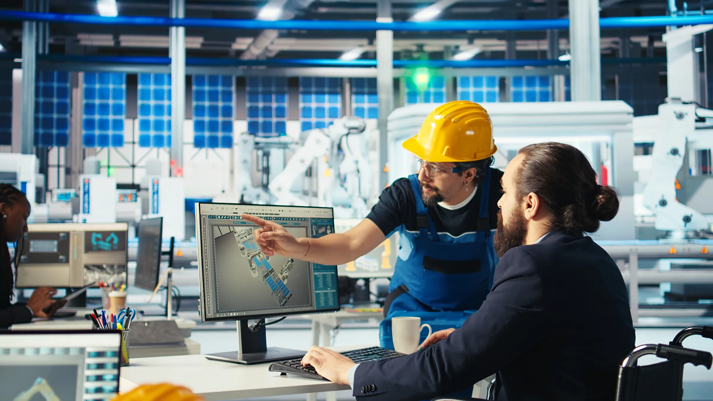 Plant supervisor and engineer reviewing solar panel schematics on screen