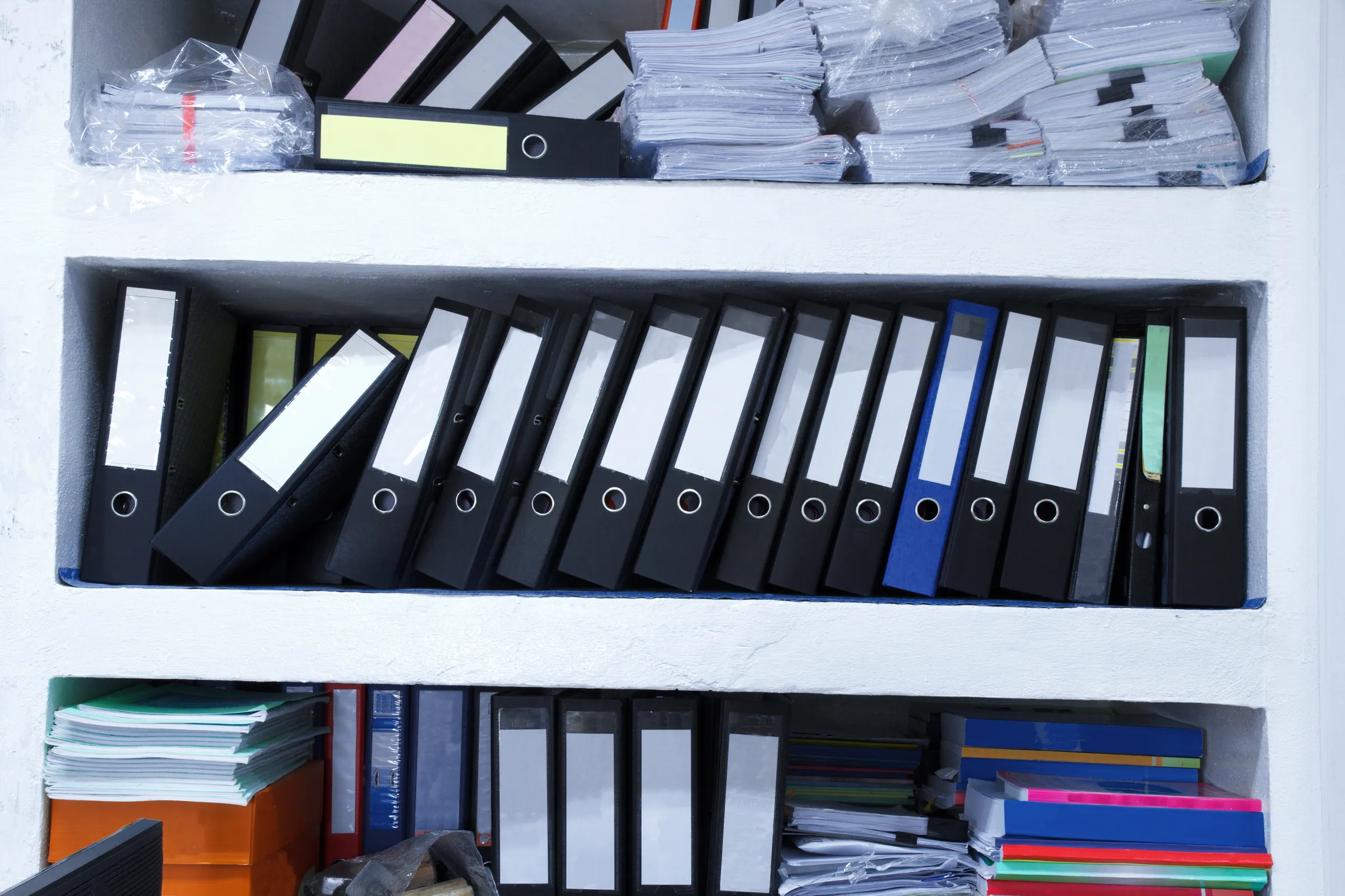 Archive shelves of ring binders in a records room