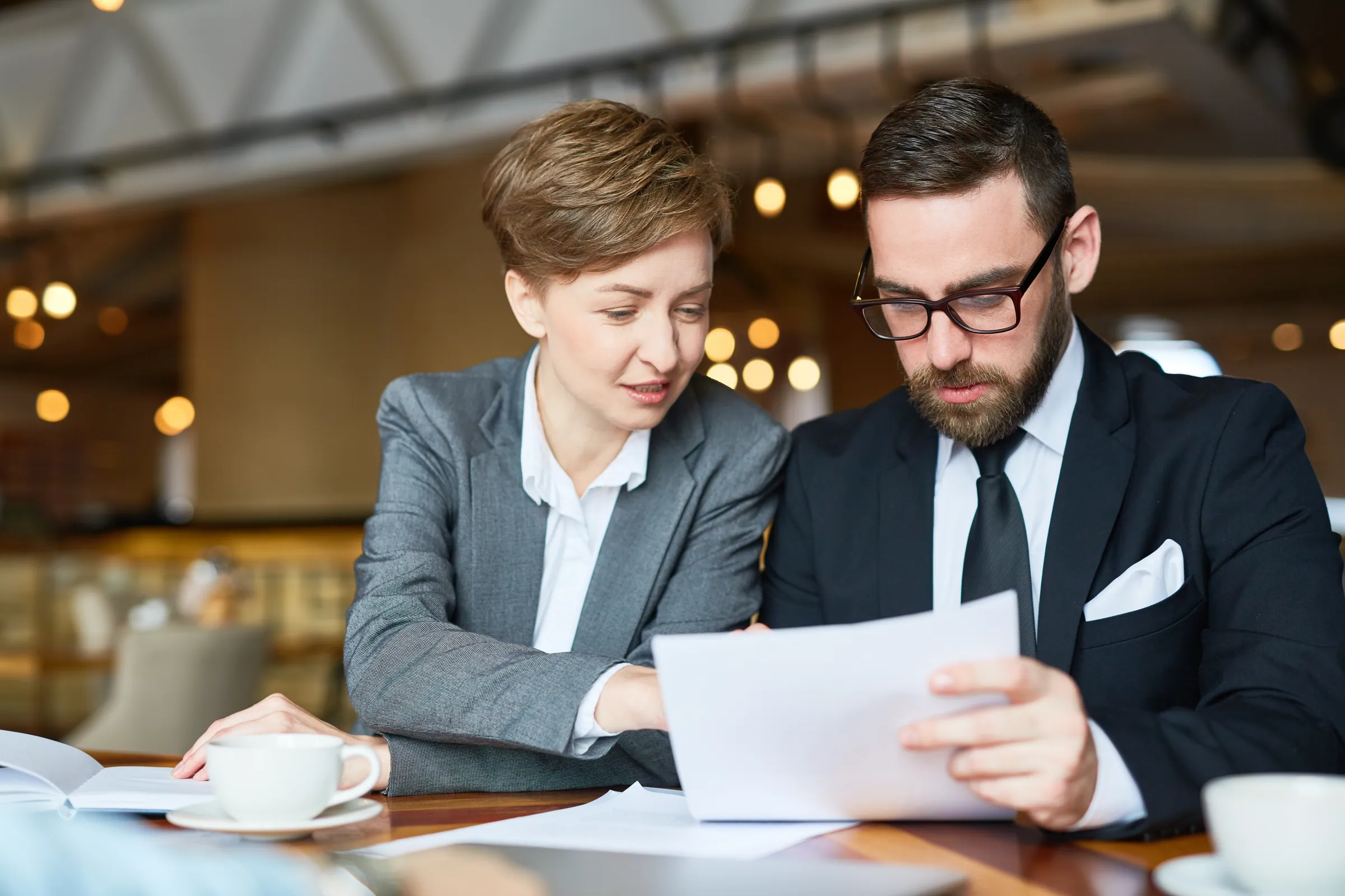 Two advisers working through contract terms