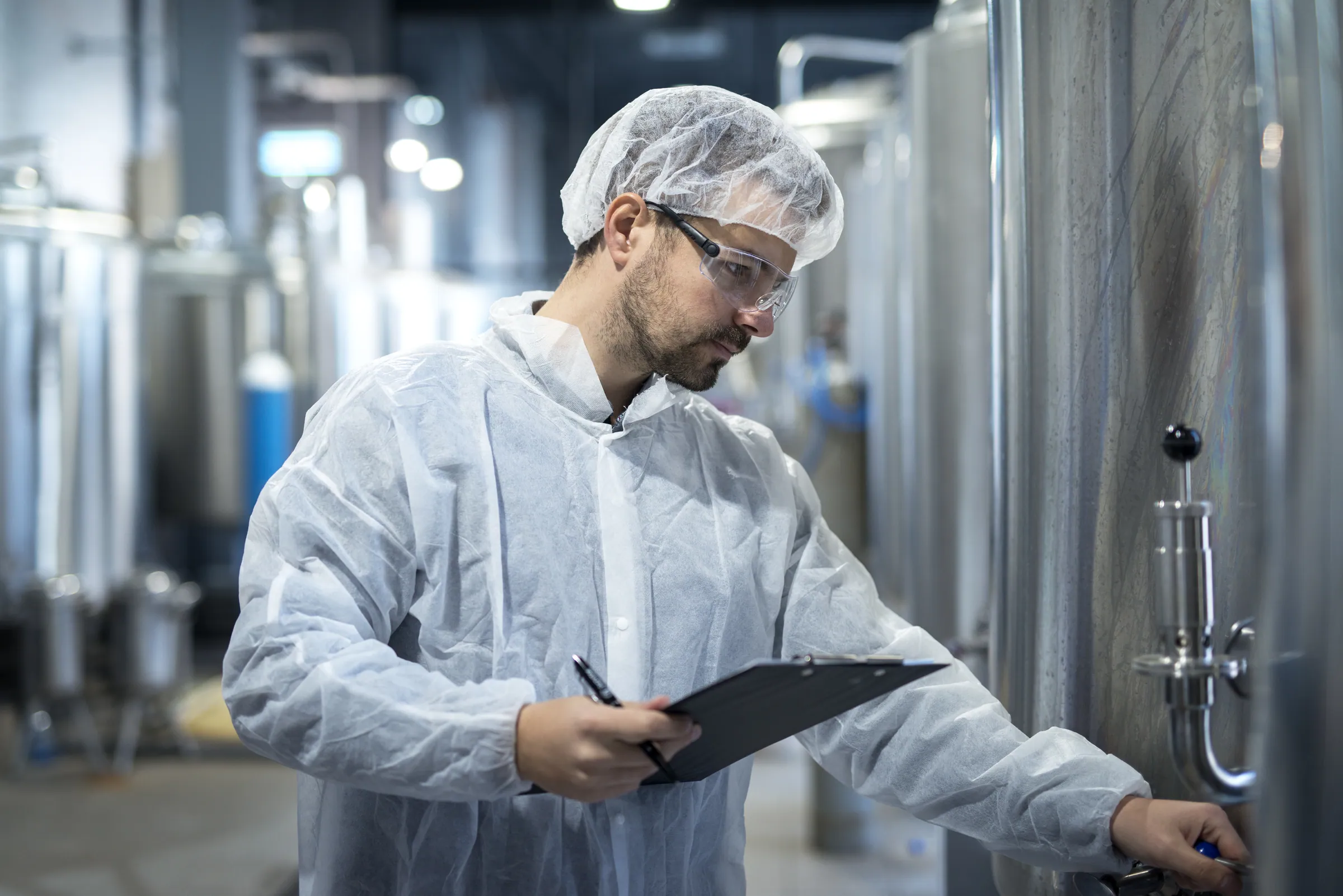 Technologist controlling a pharmaceutical processing line