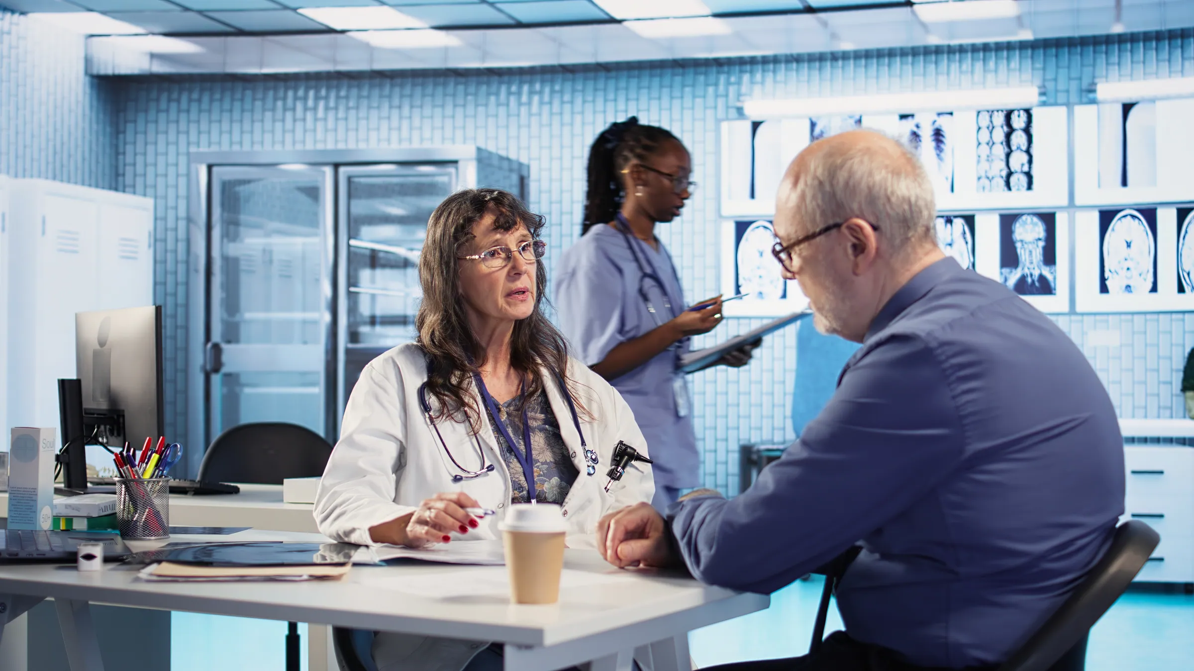 Clinician reviewing scans with a patient in a consulting room