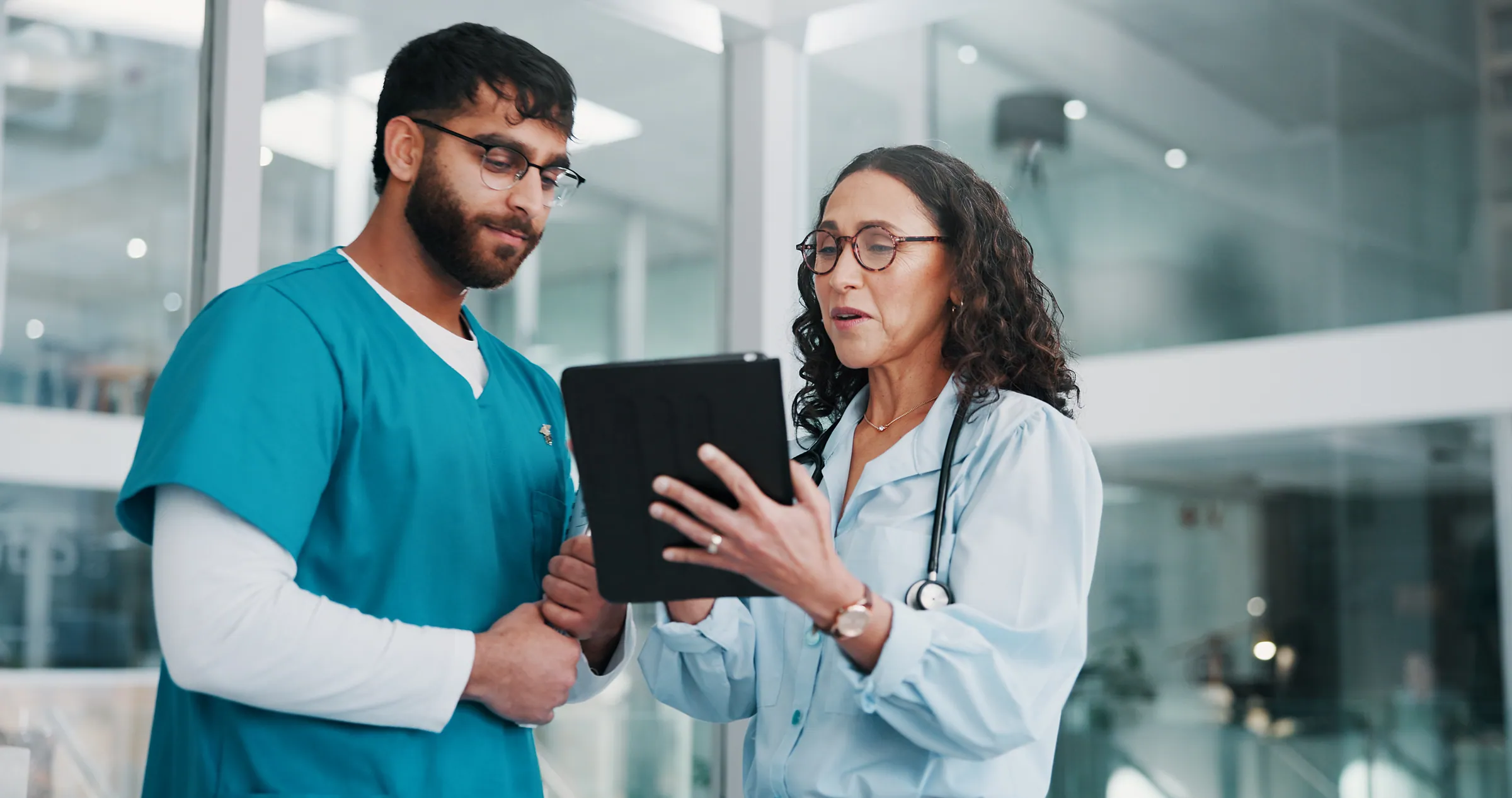 Doctor and nurse reviewing results on a tablet