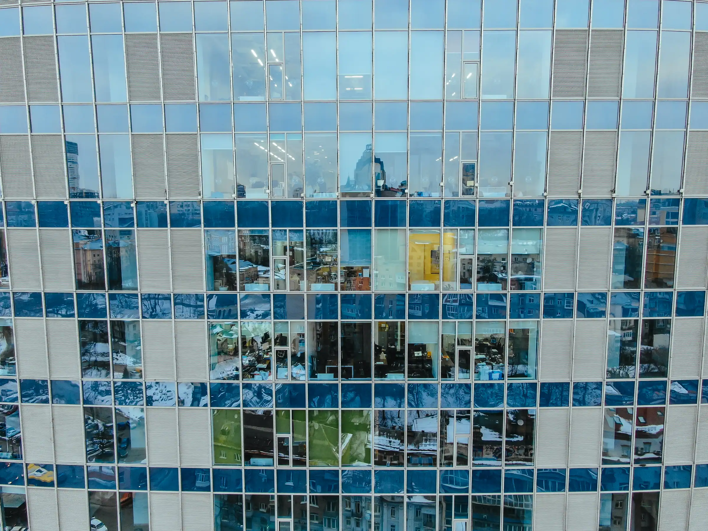 Glass and steel facade reflecting the city
