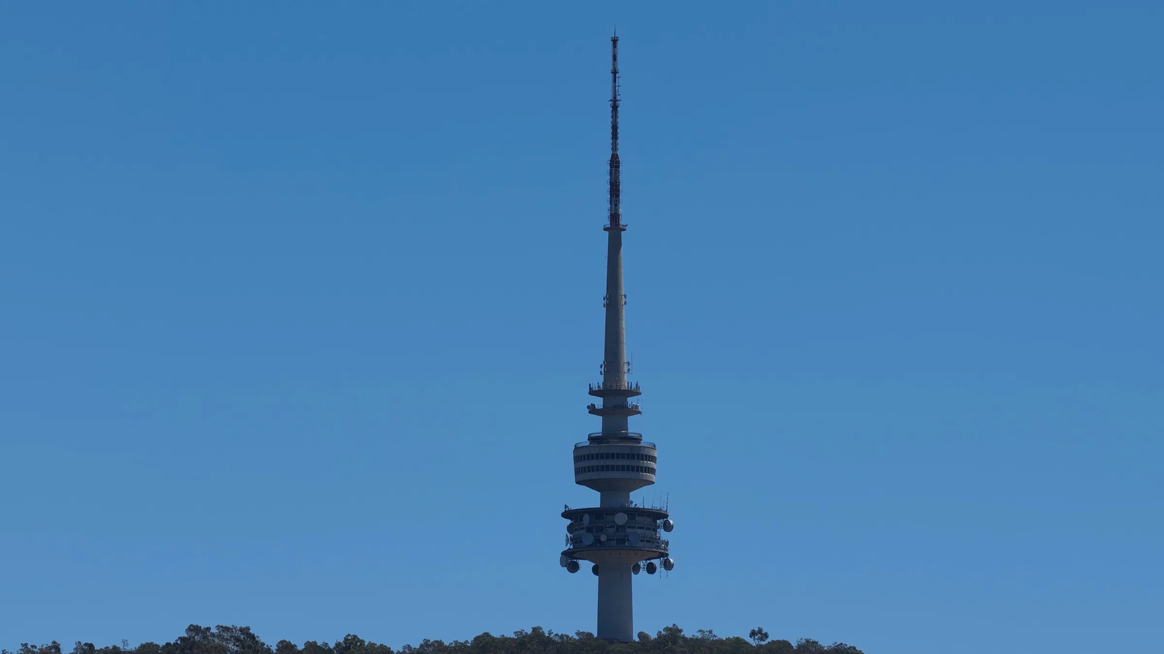Telecommunications tower against a clear blue sky