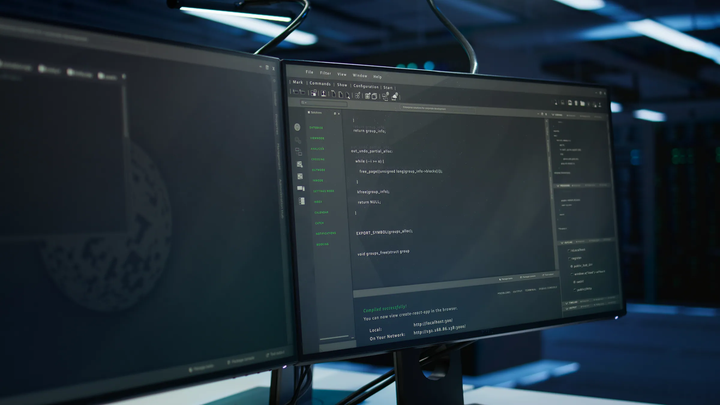 Code on a workstation monitor in a server hall, representing business-critical custom software