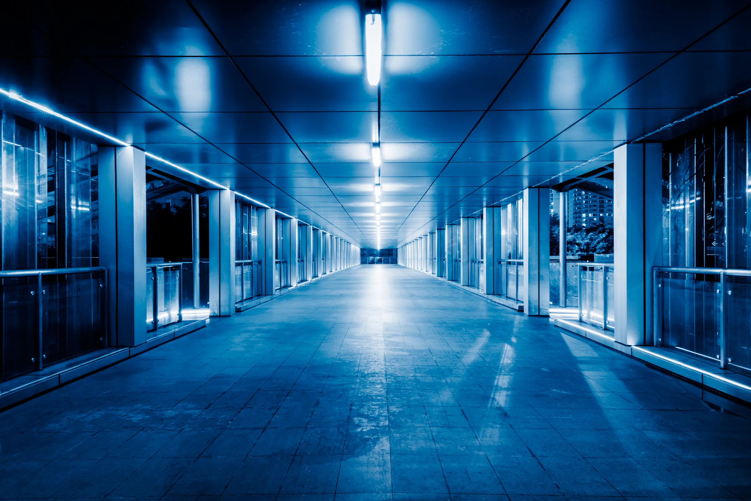 Blue-lit service corridor inside a working facility, representing the SAP core that runs an enterprise
