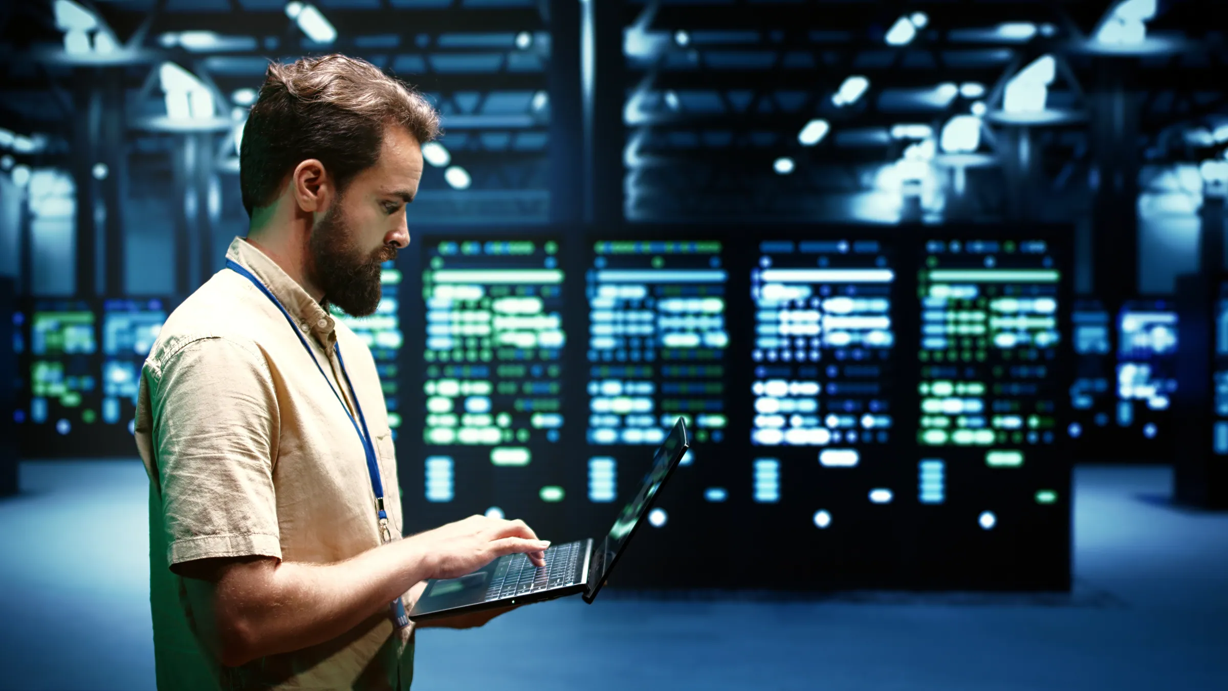 Engineer with a laptop in front of a live data hall, representing governed ServiceNow automation